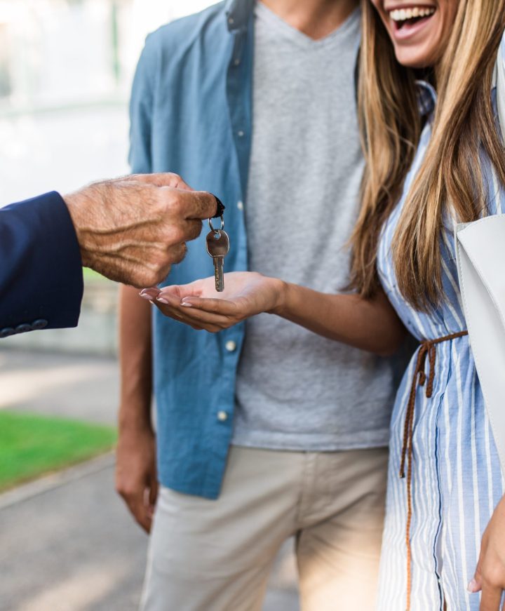 Young happy couple talking with real estate agent and buying a n Young happy couple talking with real estate agent and buying a new house.
